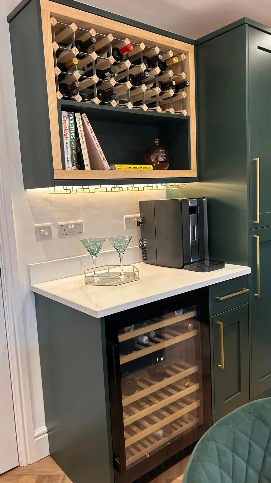 Bespoke oak wine rack and drinks station with wine cooler in a green shaker kitchen