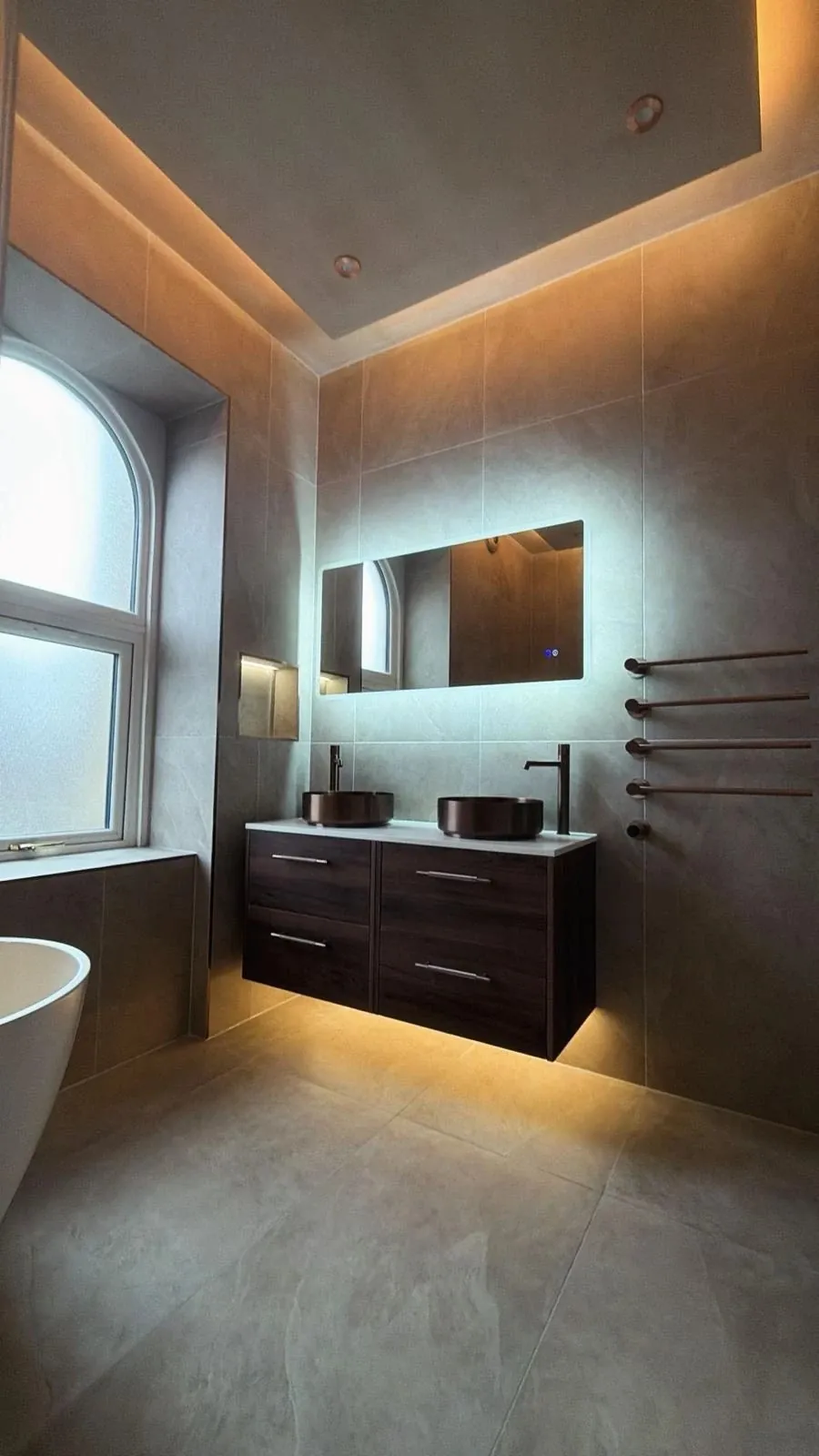 Luxury family bathroom in Keighley with bronze basins, granite worktop and drop-down lit ceiling